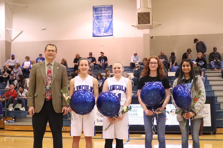 The Lincoln girls cross country team was honored for their 1A Cross Country Championship during Tuesday night's basketball games. Left-to-right: Coach Steve Crist, freshman Raegan Stewart, sophomore Jaycee Vath, freshman Shelbie Ford and senior Aubry Donley. (Photo courtesy Kae Hayworth)