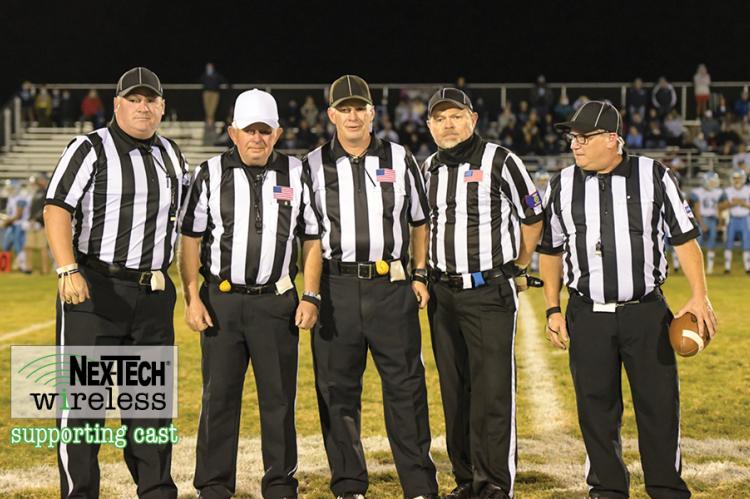 Veteran official Terrell Olson is flanked by the rest of his crew, including sons Travis and Troy, at his final game before retiring after a decades long career officiating high school sporting events in Kansas. (Photo by Karen Schroeder Photography)