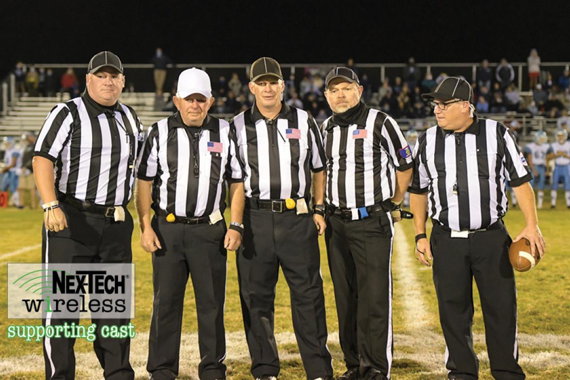 Veteran official Terrell Olson is flanked by the rest of his crew, including sons Travis and Troy, at his final game before retiring after a decades long career officiating high school sporting events in Kansas. (Photo by Karen Schroeder Photography)